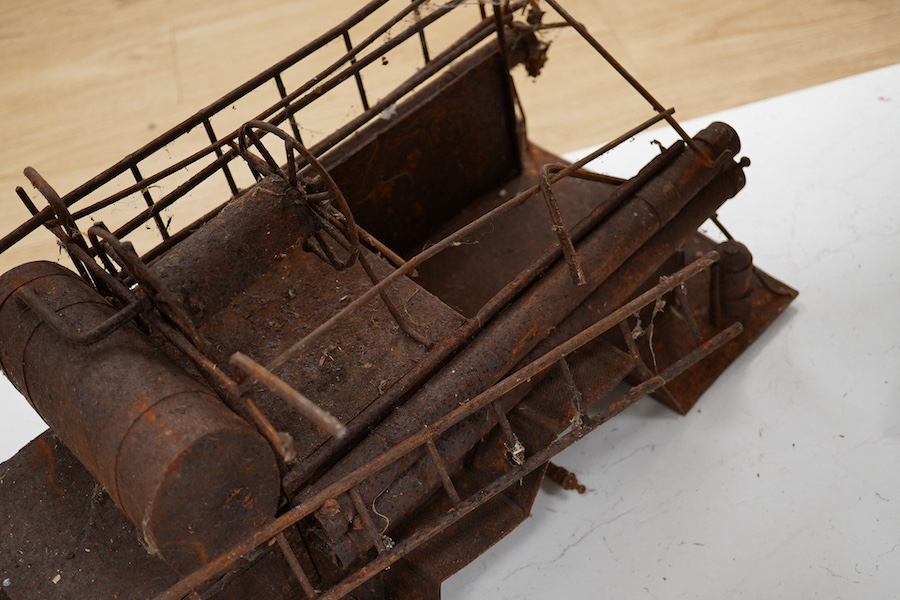 A skeleton of a toy vehicle 80cm long. Condition - rusty, without wheels